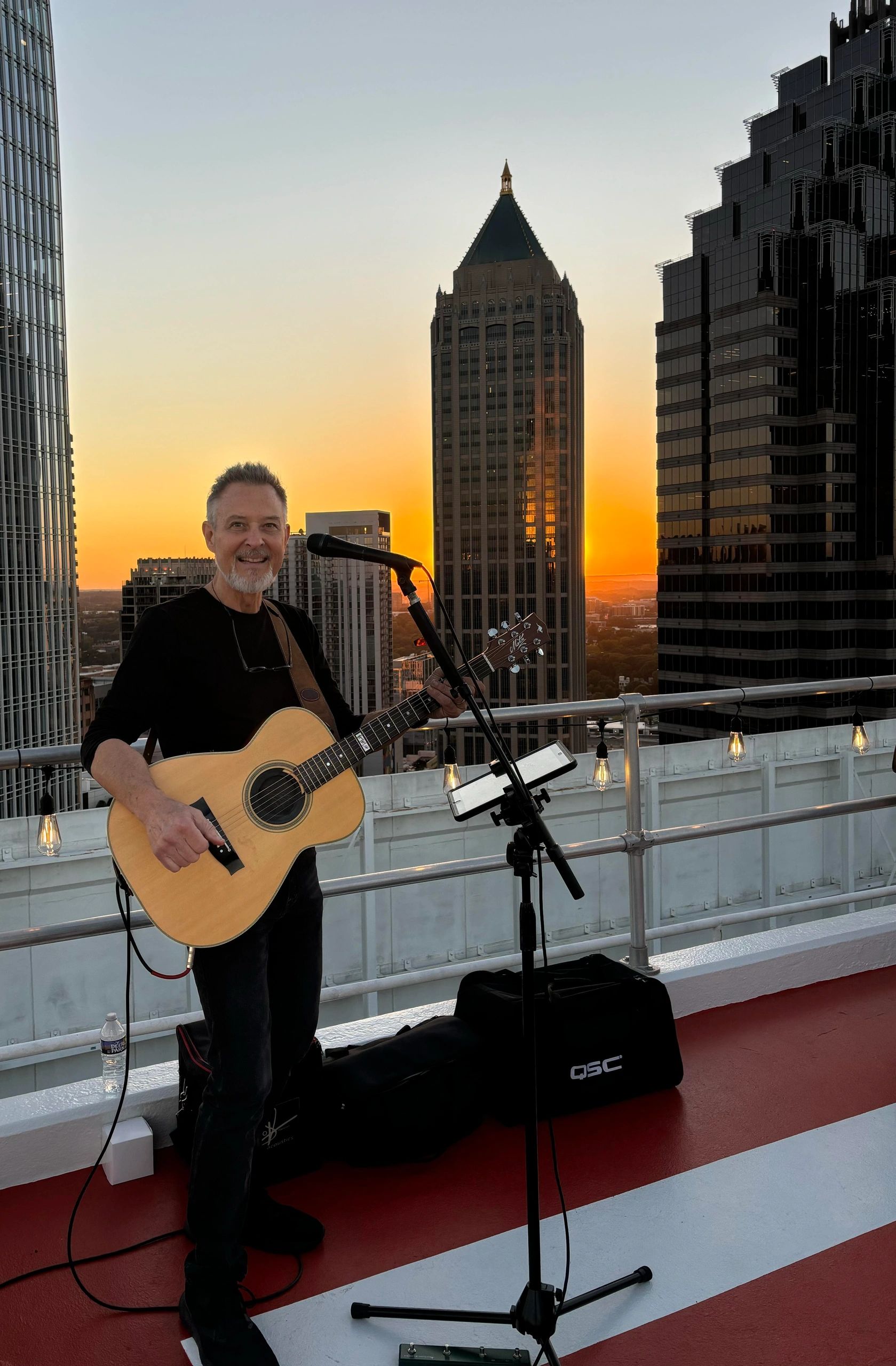 Craig Gleason performing on rooftop at sunset